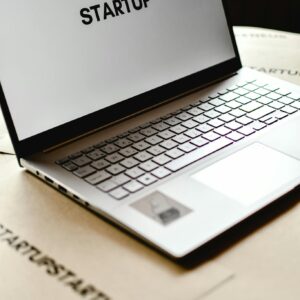 Modern laptop with startup text on screen, ideal for business themes.